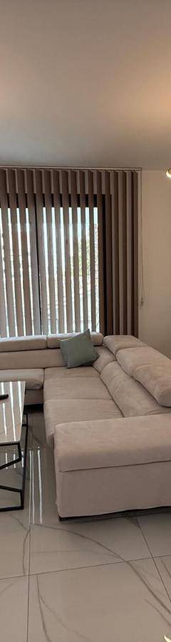 a large living room with a couch and a tv at Glabur Stays - Nicosia's Finest 2 Bedroom in Nicosia