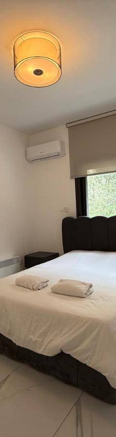 a bedroom with a bed with a black head board at Glabur Stays - Nicosia's Finest 2 Bedroom in Nicosia