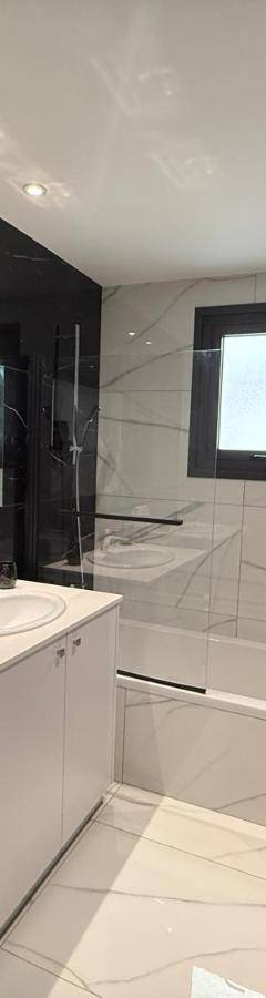 a bathroom with a white toilet and a sink at Glabur Stays - Nicosia's Finest 2 Bedroom in Nicosia