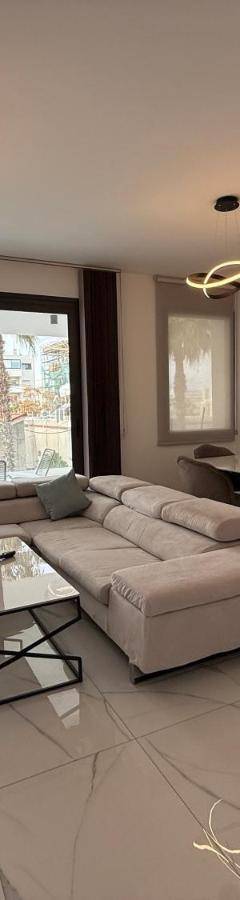 a living room with a couch and a table at Glabur Stays - Nicosia's Finest 2 Bedroom in Nicosia