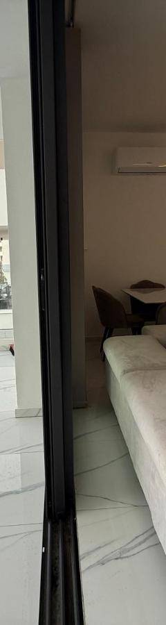 a living room with a couch and a table and chairs at Glabur Stays - Nicosia's Finest 2 Bedroom in Nicosia