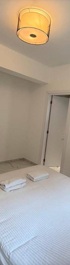 a bedroom with a white bed and a light at Glabur Stays - Nicosia's Finest 2 Bedroom in Nicosia