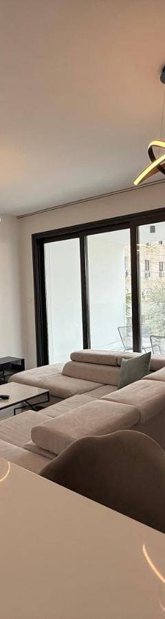a living room with a couch and a tv at Glabur Stays - Nicosia's Finest 2 Bedroom in Nicosia