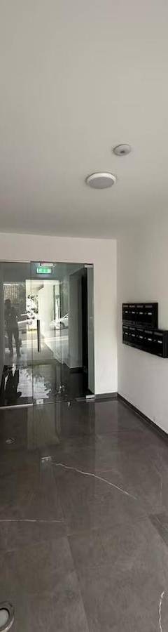 a hallway of an office building with a wooden door at Glabur Stays - Nicosia's Finest 2 Bedroom in Nicosia