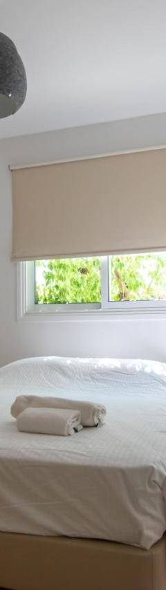 a white bedroom with a bed and a window at Glabur Stays - The Master Atelier - Nicosia City, Free Parking &amp; Wifi, Welcomes You!!! in Nicosia
