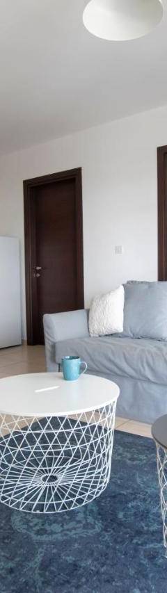a living room with a blue couch and a kitchen at Glabur Stays - The Master Atelier - Nicosia City, Free Parking &amp; Wifi, Welcomes You!!! in Nicosia