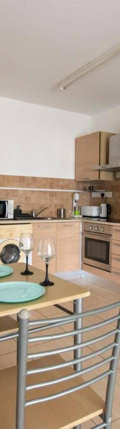 a kitchen with a table and a refrigerator at Glabur Stays - The Master Atelier - Nicosia City, Free Parking &amp; Wifi, Welcomes You!!! in Nicosia