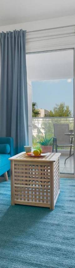 a living room with a blue couch and a table at Glabur Stays - The Cozy Atelier - Nicosia City, Free Parking &amp; Wifi, Welcomes You!!! in Nicosia