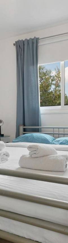 a bedroom with a bed with a painting on the wall at Glabur Stays - The Cozy Atelier - Nicosia City, Free Parking &amp; Wifi, Welcomes You!!! in Nicosia