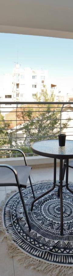 a table and two chairs on a balcony at Glabur Stays - The Cozy Atelier - Nicosia City, Free Parking &amp; Wifi, Welcomes You!!! in Nicosia