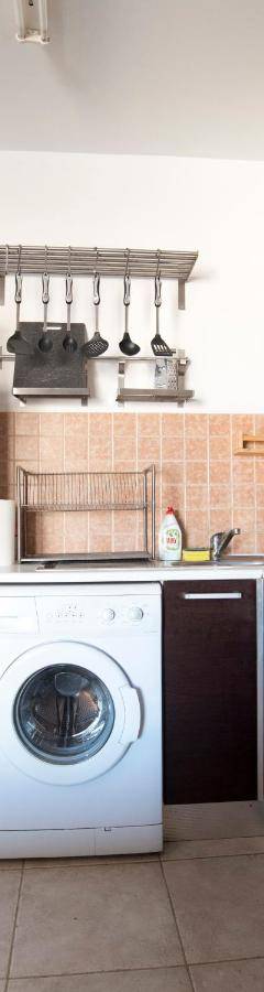 a kitchen with a washing machine and a refrigerator at Glabur Stays - The Cozy Atelier - Nicosia City, Free Parking &amp; Wifi, Welcomes You!!! in Nicosia