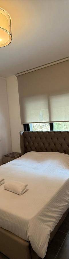 a small bedroom with a bed and white cabinets at Glabur Stays - Nicosia Elite 2BDR in Nicosia