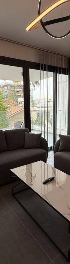 a living room with a couch and a table at Glabur Stays - Nicosia Elite 2BDR in Nicosia