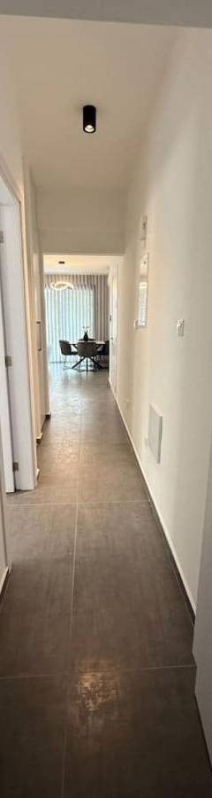a hallway with white walls and a long hallway at Glabur Stays - Nicosia Elite 2BDR in Nicosia