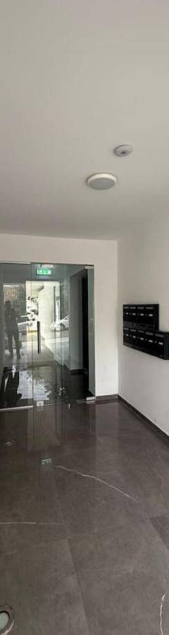an empty room with a hallway with a wooden door at Glabur Stays - Nicosia Elite 2BDR in Nicosia