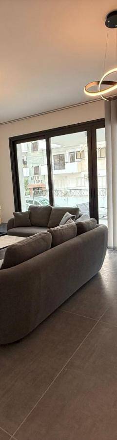 a living room with a couch and tables and a tv at Glabur Stays - Nicosia Elite 2BDR in Nicosia