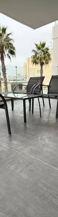 a patio with chairs and a table on a balcony at Glabur Stays - Nicosia Elite 2BDR in Nicosia