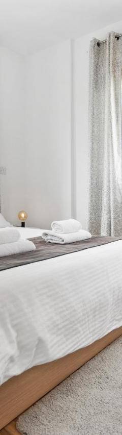 a white bedroom with a large bed and windows at Glabur Stays - The Nicosia Elite - Exceptional Top Floor Apartment Nicosia City, Welcomes U!!! in Nicosia