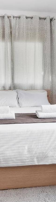 a bedroom with a large bed and a large window at Glabur Stays - The Nicosia Elite - Exceptional Top Floor Apartment Nicosia City, Welcomes U!!! in Nicosia