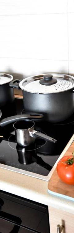 a kitchen with a stove with pots and pans and vegetables at Glabur Stays - The Nicosia Elite - Exceptional Top Floor Apartment Nicosia City, Welcomes U!!! in Nicosia