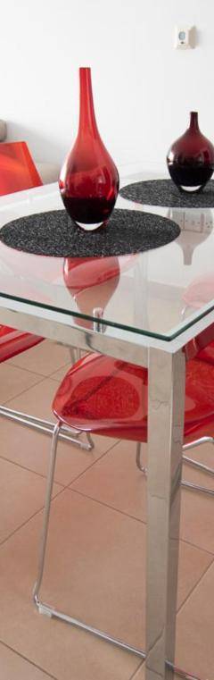 a glass table with red chairs and a couch at Glabur Stays - The Nicosia Elite - Exceptional Top Floor Apartment Nicosia City, Welcomes U!!! in Nicosia