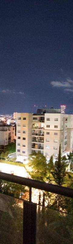 a view of a city at night from a balcony at Glabur Stays - The Nicosia Elite - Exceptional Top Floor Apartment Nicosia City, Welcomes U!!! in Nicosia