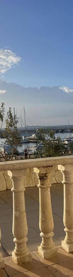a white chair sitting on a balcony overlooking the water at Glabur Stays! The One -1 - Elite Marina Front! in Zygi