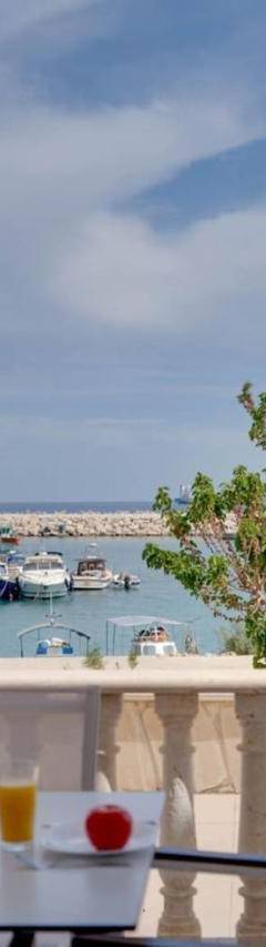 a table and chairs on a balcony with a marina at Glabur Stays! The One -1 - Elite Marina Front! in Zygi