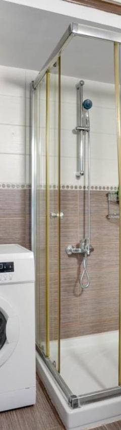 a bathroom with a toilet and a washing machine at Glabur Stays! The One -1 - Elite Marina Front! in Zygi