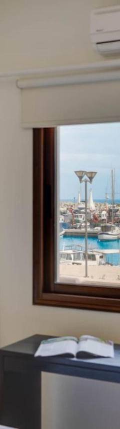 a bedroom with a window and a view of a pool at Glabur Stays! The One -1 - Elite Marina Front! in Zygi