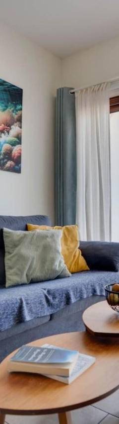 a living room with a blue couch and a table at Glabur Stays! The One -1 - Elite Marina Front! in Zygi