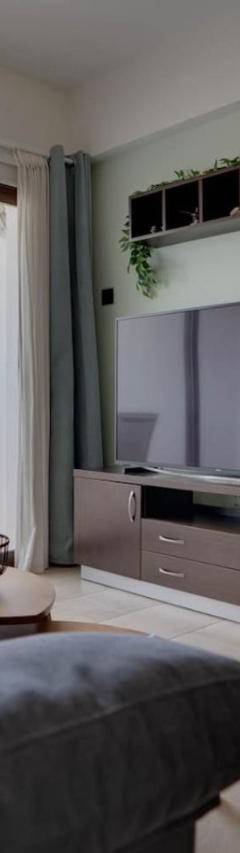 a living room with a couch and a television at Glabur Stays! The One -1 - Elite Marina Front! in Zygi