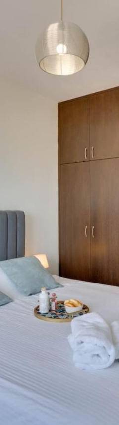 a bedroom with a bed with towels on it at Glabur Stays! The One -1 - Elite Marina Front! in Zygi