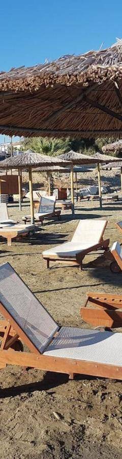 a bunch of chairs and umbrellas on a beach at Glabur Stays! The One -1 - Elite Marina Front! in Zygi