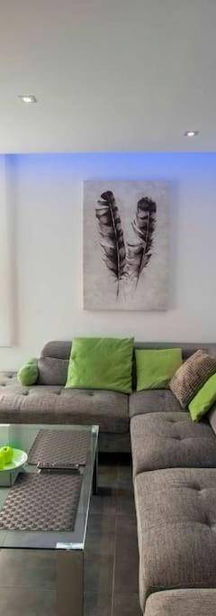 a living room with a couch and a flat screen tv at Glabur Stays - The Amazing 1 BDR - Executive apt Nicosia Center Free Parking &amp; WiFi in Nicosia