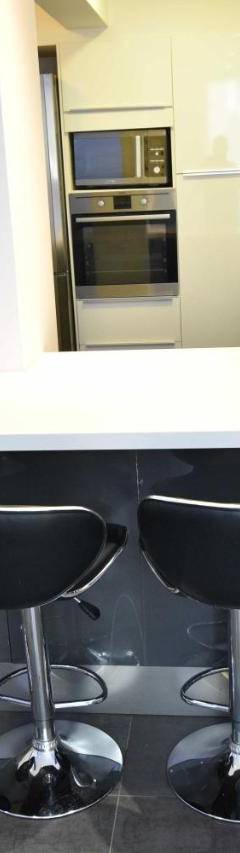 a kitchen with a counter and four bar stools at Glabur Stays - The Amazing 1 BDR - Executive apt Nicosia Center Free Parking &amp; WiFi in Nicosia