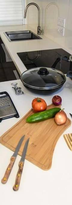 a kitchen counter with vegetables on a cutting board at Glabur Stays - The Amazing 1 BDR - Executive apt Nicosia Center Free Parking &amp; WiFi in Nicosia