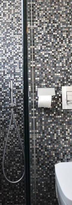 a bathroom with a shower with a toilet and a sink at Glabur Stays - The Amazing 1 BDR - Executive apt Nicosia Center Free Parking &amp; WiFi in Nicosia