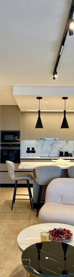 a kitchen and living room with a table and chairs at Sweet Luxury 2BR Nicosia City in Nicosia