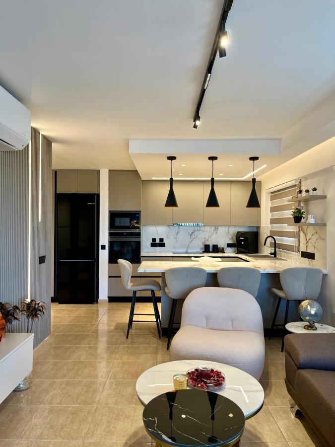 a kitchen and living room with a table and chairs at Sweet Luxury 2BR Nicosia City in Nicosia
