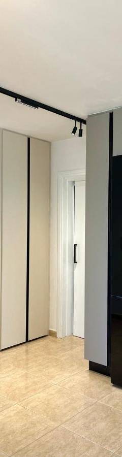 a living room with a large black refrigerator at Sweet Luxury 2BR Nicosia City in Nicosia