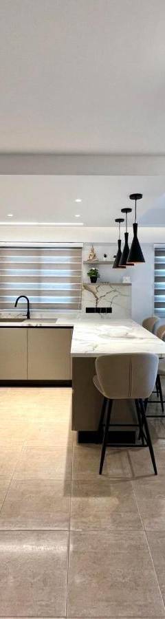 a kitchen with a table and some chairs in it at Sweet Luxury 2BR Nicosia City in Nicosia