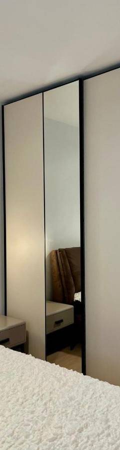 a bedroom with a large closet with mirrored doors at Sweet Luxury 2BR Nicosia City in Nicosia