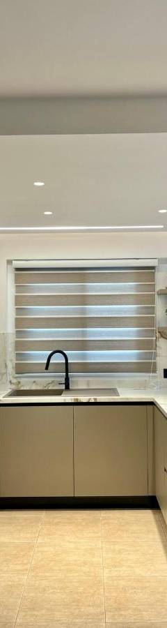 a kitchen with white cabinets and a sink at Sweet Luxury 2BR Nicosia City in Nicosia