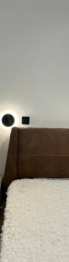 a bed with a heart pillow on the wall at Sweet Luxury 2BR Nicosia City in Nicosia