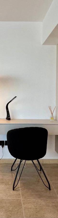 a desk with a lamp and a chair in a room at Sweet Luxury 2BR Nicosia City in Nicosia