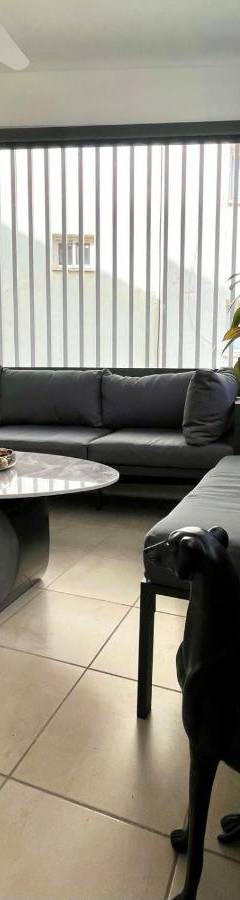a black dog standing in a living room with a table at Sweet Luxury 2BR Nicosia City in Nicosia