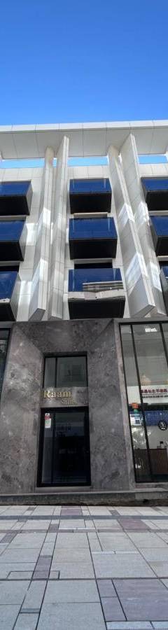 a large building with windows on the side of it at Raam Luxury Suites in Larnaka