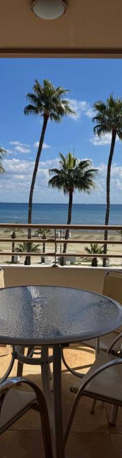 a table and chairs on a balcony with a view of the ocean at Ithaki Phinikoudes Apartment No. 201 in Larnaka