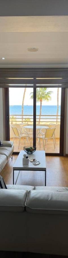a living room with a couch and a view of the ocean at Ithaki Phinikoudes Apartment No. 201 in Larnaka
